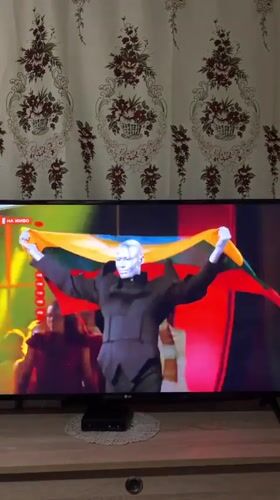 Eurovision viewer waves Bulgarian flag during broadcast in Lozarevo