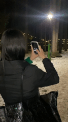 Woman poses for nighttime photo session at winter park in Russia