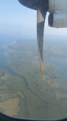 Aerial view captured from aircraft window over Dapa, Philippines