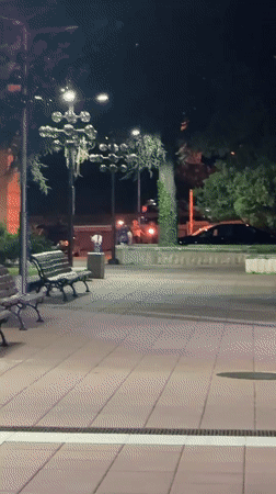 Person kneels with lit torches on Blagoevgrad walkway