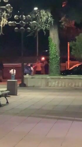 Person kneels with lit torches on Blagoevgrad walkway