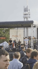 Band performs at outdoor festival in Prague near Žižkov Tower