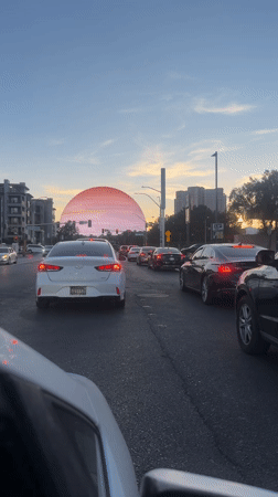 Traffic stops near glowing sphere structure in Las Vegas