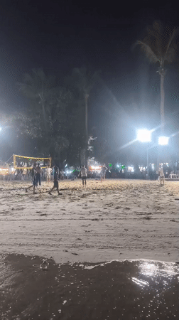 Patong Beach after dark — volleyball, shoreline strolls, city glow