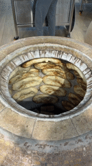Flatbread coming out of a tandoor in Aparan, Armenia