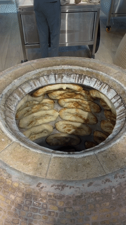 Flatbread coming out of a tandoor in Aparan, Armenia