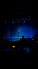 Live vocal performance under moody stage lighting in Buenos Aires