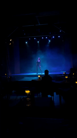 Live vocal performance under moody stage lighting in Buenos Aires