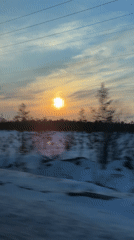 Winter sunset observed over snow-covered Russian field
