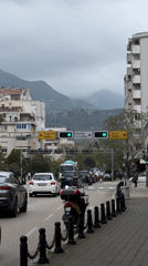 Man walks along sidewalk during overcast day in Bar, Montenegro