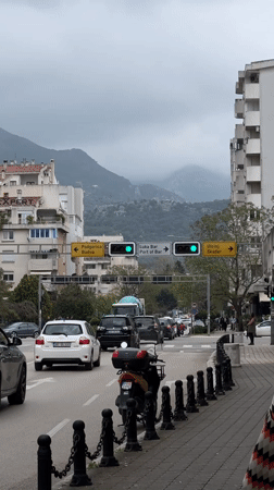Man walks along sidewalk during overcast day in Bar, Montenegro
