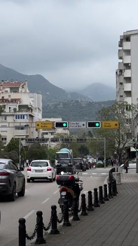Man walks along sidewalk during overcast day in Bar, Montenegro