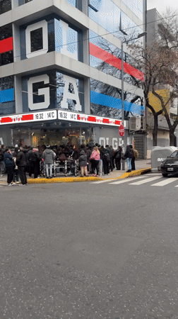 Customers queue outside OLGA store in Buenos Aires