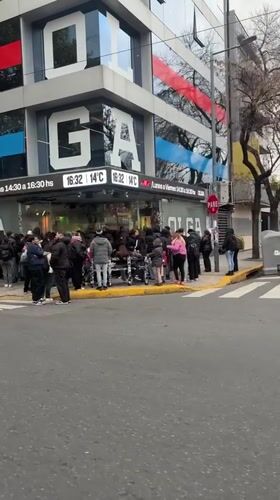Customers queue outside OLGA store in Buenos Aires