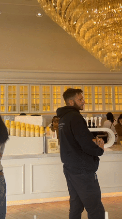 Los Angeles cafe interior captured with ornate chandelier, waiting patrons