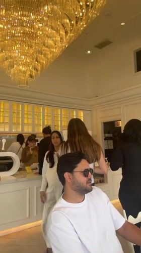 Los Angeles cafe interior captured with ornate chandelier, waiting patrons