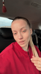 Woman in red jacket photographed in car backseat, Razdol'e