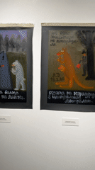 Art gallery display with four paintings documented in Tbilisi