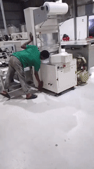 Factory workers perform routine cleaning and maintenance tasks