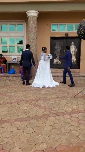 Wedding photoshoot captured outside building in Onitsha, Nigeria