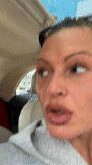 Woman applies MAC lip pencil in car, Tunbridge Wells