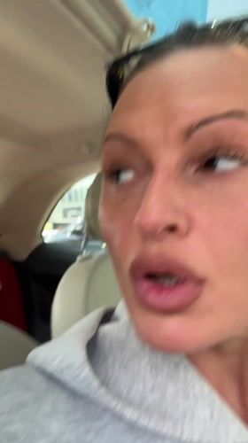 Woman applies MAC lip pencil in car, Tunbridge Wells