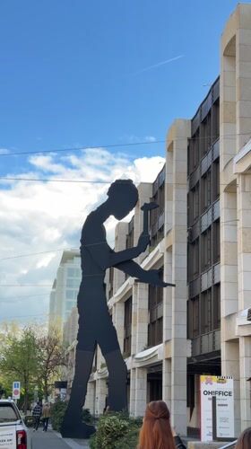 Basel morning streetscape captured through sculptures, transit, architecture