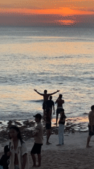 Beach goers enjoy typical day at Kuta Selatan
