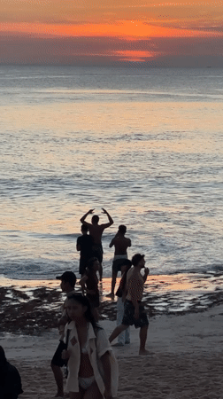 Beach goers enjoy typical day at Kuta Selatan