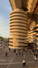 Crowds gather at Milan stadium displaying football club commemorative plaques