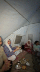 Groups gather inside tent for meals and social time