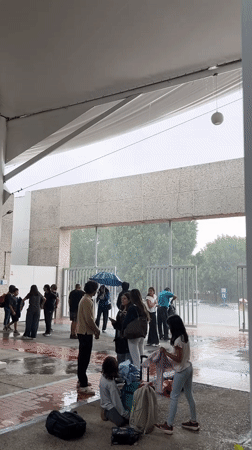 Students shelter from heavy rain at Puebla educational facility
