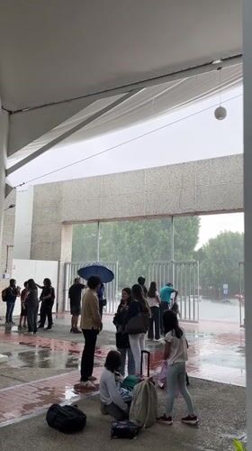 Students shelter from heavy rain at Puebla educational facility