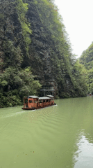 Tour boat carries passengers through scenic Zhangjiajie river canyon