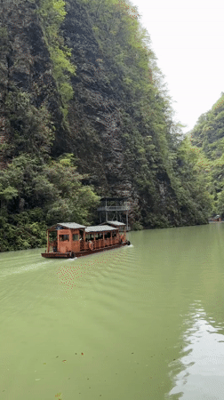 Tour boat carries passengers through scenic Zhangjiajie river canyon