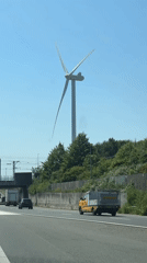 Highway drive near The Hague features wind turbine view