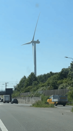 Highway drive near The Hague features wind turbine view