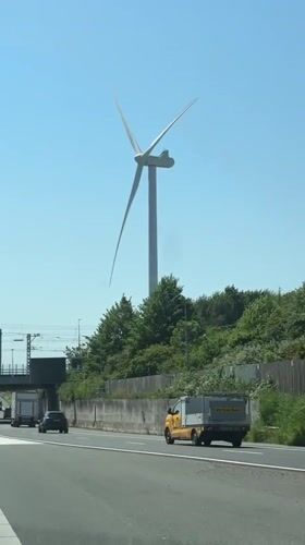 Highway drive near The Hague features wind turbine view