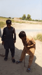 Kids playing marbles and goofing around in rural Gurmaniwali