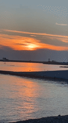 Sunset over the Black Sea in Sochi, with construction nearby