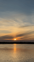 Woman photographed during sunset by Kama River in Chaikovsky
