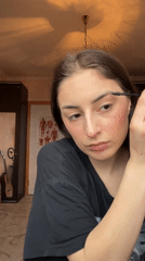 Woman's morning makeup routine captured in Moscow bedroom
