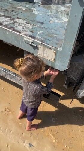 Daily survival in a Gaza displacement camp, water and debris.