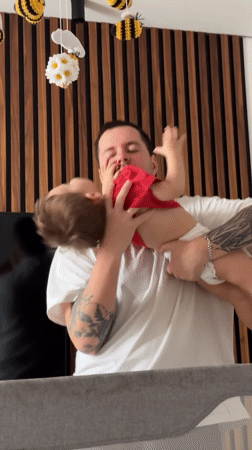 Man comforts toddler in Odintsovo home