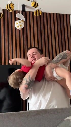 Man comforts toddler in Odintsovo home