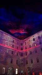 Dynamic light show illuminates Vienna building courtyard at night