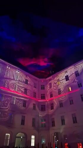 Dynamic light show illuminates Vienna building courtyard at night