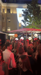 Urban evening scenes: street musician, crowds, commercial activity