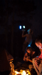 Nighttime campfire gathering with music and juggling near Da Lat