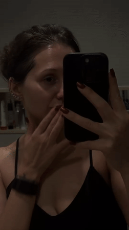 Woman documents skincare routine in Dubai bathroom selfie video